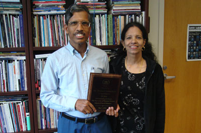 Mel Damodaran, left, a professor of math and computer science at the University of Houston-Victoria, and his wife, Padmini, hold a plaque he received from the School of Arts & Sciences for his nearly 20 years of service at the university. 