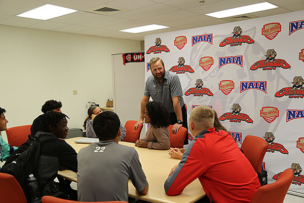 Adrian Rigby, standing, UHV assistant athletic director, explains the new Jobs After Graduation program Thursday to freshman athletes.