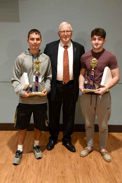Drew Powell, a Hallettsville High School senior, and Michael Di Santo, a Victoria West High School senior, stand with UHV president Vic Morgan