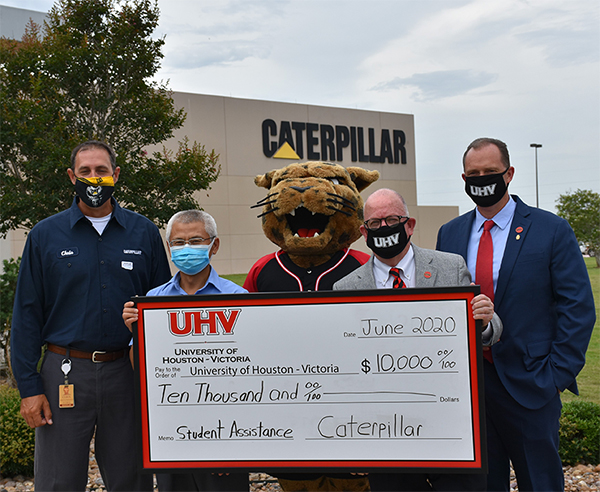Officials from Caterpillar Victoria and UHV pose in June outside the Caterpillar Victoria facility.