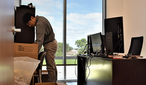 Gen Kaneko, UHV assistant professor of biology moving into his new office in University South.