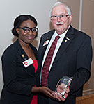 Ke’Andre Green, left, smiles after UHV President Vic Morgan presents her with the Student Leadership Award.