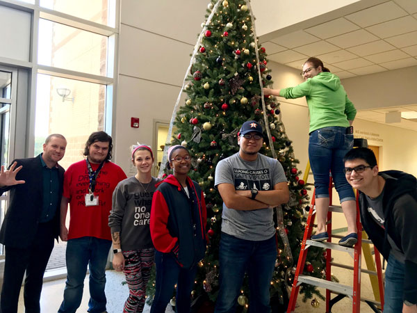 Michael Wilkinson, director of UHV Student Life & Services, helps decorate the UHV Giving Tree on Monday with freshman seminar students.