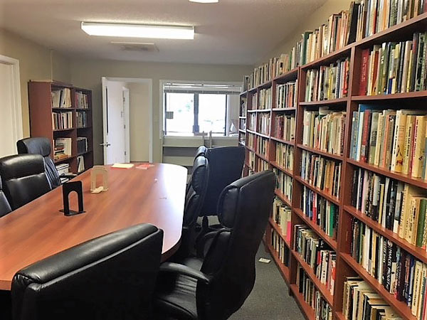 photo of an empty UHV conference room with a full bookshelf on the right
