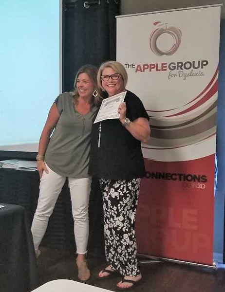Carol Klages, right, a University of Houston-Victoria associate professor of Education and a dyslexia specialist, receives her certified dyslexia therapist license