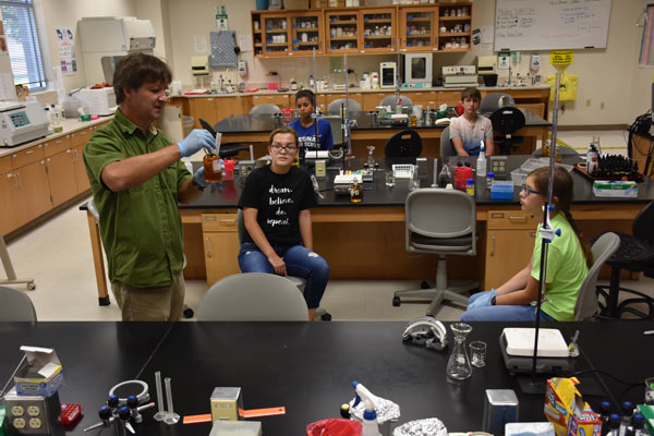 Dmitri Sobolev, left, a UHV associate professor of biology, explains how to measure out a treated water sample on Saturday to Emilie Janicek, front middle, a freshman at Nixon-Smiley High School; Ariana Owens, back left, a sophomore at Edna High School; Landon Atkins, back right, a seventh-grader at Nixon-Smiley Middle School; and Stephanie Banditrat, a seventh-grader at Labay Middle School in Houston. The four students attended the UHV Aquatic Sciences Summer Camp