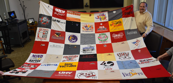 UHV retiree Joe Ferguson displays a quilt Thursday that he had made from 49 shirts he accumulated during his 42 years working at UHV