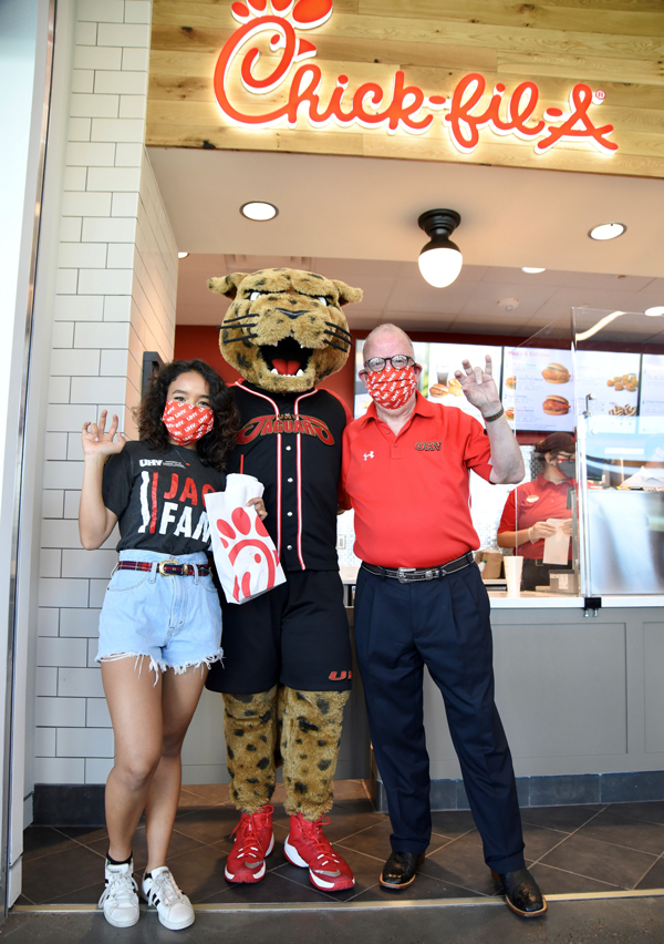 Tiarah Figueroa, left, president of the UHV Student Government Association; UHV mascot jaX; and UHV President Bob Glenn are the first customers on Wednesday at the new Chick-fil-A inside UHV University Commons. Chick-fil-A and the Jaguar Java coffee shop and market opened as students began moving into the university’s residence halls. 