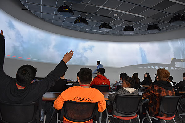 Daniel White, a University of Houston-Victoria assistant professor of biology and program coordinator for the UHV biology and chemistry programs, shows Stroman Middle School students a video of a rollercoaster in UHV’s visualization theater Tuesday during Stroman STEM Academy’s field trip to the campus. About 170 students in the Stroman STEM Academy visited the UHV campus Tuesday and Wednesday and met with UHV biology, computer science and mathematics faculty to learn about STEM subjects. Throughout the two days, the students participated in demonstrations including extracting DNA from fruit, chemistry reactions, computer robotics and magic tricks involving math.